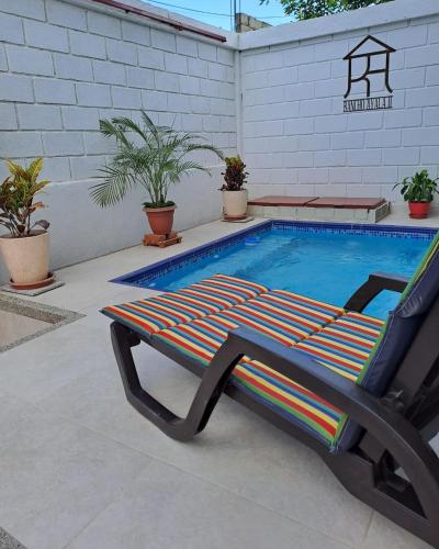 a lounge chair sitting next to a swimming pool at Rancho Ayala II in Santa Marta