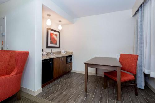 a room with a table and chairs and a sink at Hampton Inn Santa Barbara/Goleta in Santa Barbara