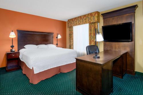 a hotel room with a bed and a flat screen tv at Hampton Inn & Suites Sacramento-Elk Grove Laguna I-5 in Elk Grove