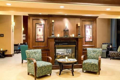 a lobby with a fireplace and chairs and a table at Hampton Inn & Suites Sacramento-Elk Grove Laguna I-5 in Elk Grove