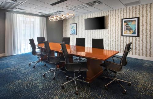 a conference room with a wooden table and chairs at Homewood Suites by Hilton Newburgh-Stewart Airport in New Windsor