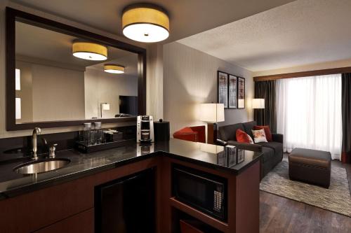 a hotel room with a kitchen and a living room at Embassy Suites by Hilton Washington DC Chevy Chase Pavilion in Washington