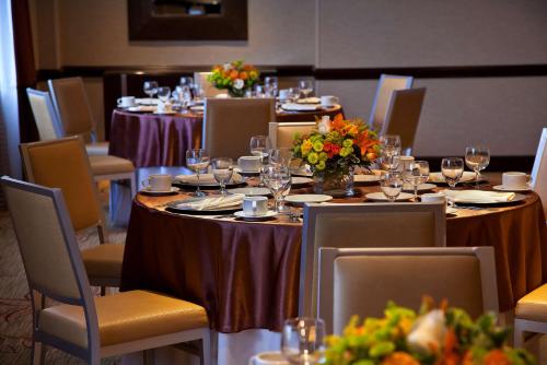 a group of tables with wine glasses and flowers on them at Embassy Suites by Hilton Washington DC Chevy Chase Pavilion in Washington