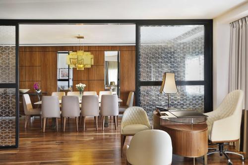 a dining room with a table and chairs at Transcorp Hilton Abuja in Abuja