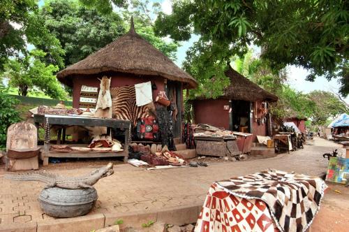 a market with a building with a store with meat at Transcorp Hilton Abuja in Abuja