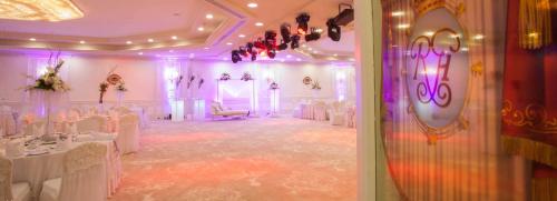a banquet hall with white tables and chairs and purple lighting at Hilton Alexandria Corniche Hotel in Alexandria