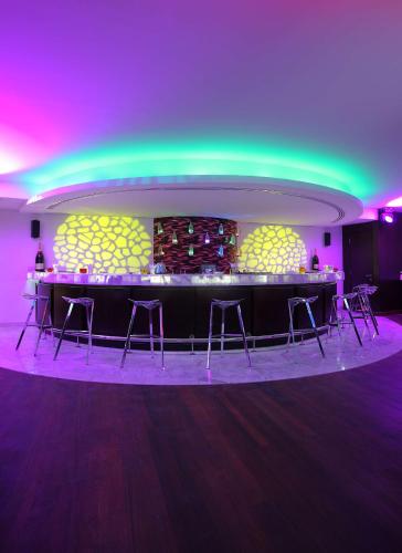 a bar in a room with purple and green lights at Hilton Alexandria Corniche Hotel in Alexandria