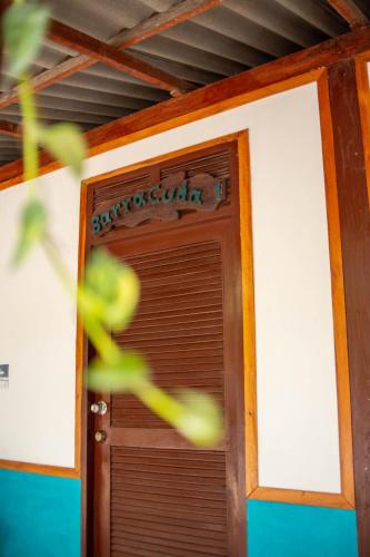 a close up of a wooden door in a room at Isla Grande Eco-Hostal in Isla Grande