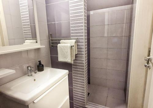 a bathroom with a sink and a mirror at Dora Holiday House & Apartments in Keszthely