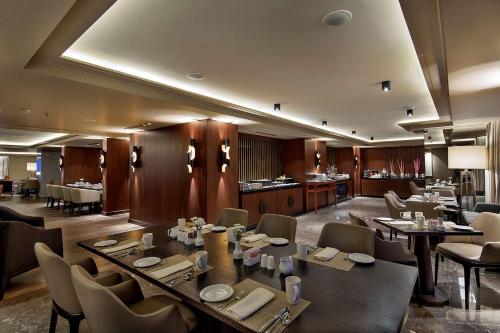 a dining room with tables and chairs in a restaurant at Ankara HiltonSA in Ankara