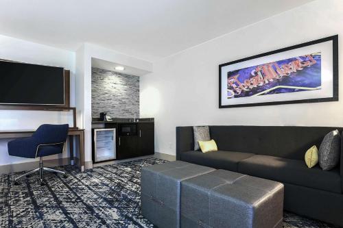 a living room with a couch and a flat screen tv at Hampton Inn & Suites Austin - Downtown in Austin