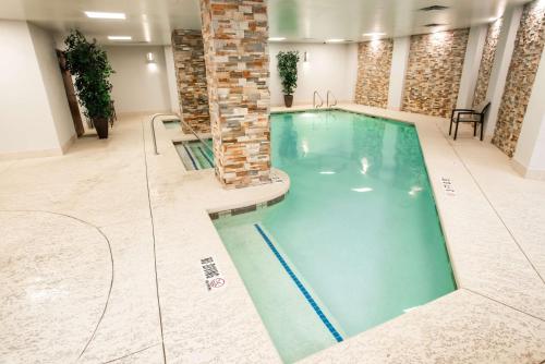 a swimming pool in a building with a person in it at Embassy Suites by Hilton Austin Downtown South Congress in Austin