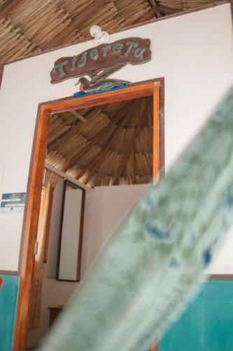 a sign on the wall of a room at Isla Grande Eco-Hostal in Isla Grande