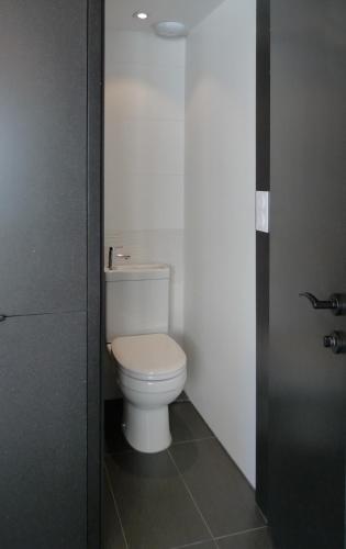 - une salle de bains avec des toilettes blanches dans une cabine dans l'établissement Chalet*** au pied d'une prairie face à la montagne, à Sixt-Fer-à-Cheval