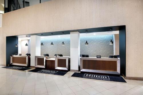 a row of urinals in a public restroom at DoubleTree by Hilton Stamford in Stamford