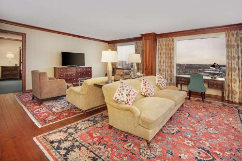 a living room with a couch and chairs at DoubleTree by Hilton Stamford in Stamford