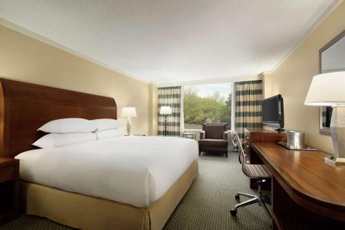 a hotel room with a bed and a desk and a computer at DoubleTree by Hilton Stamford in Stamford