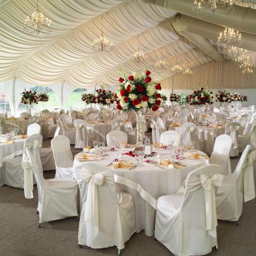 a large tent with white tables and chairs and flowers at DoubleTree by Hilton Stamford in Stamford