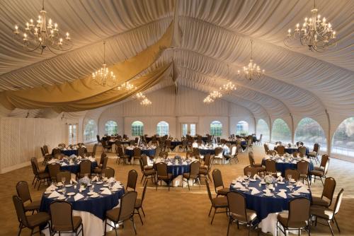 a banquet hall with tables and chairs in a tent at DoubleTree by Hilton Stamford in Stamford