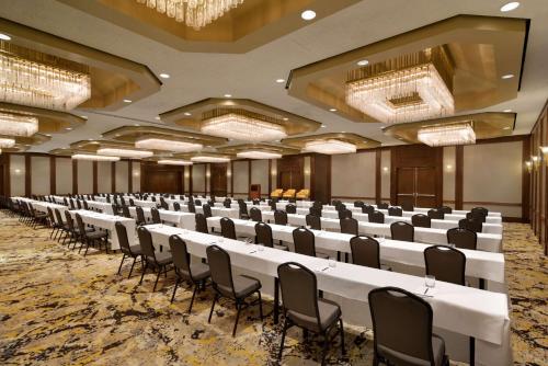 a large room with rows of tables and chairs at DoubleTree by Hilton Stamford in Stamford