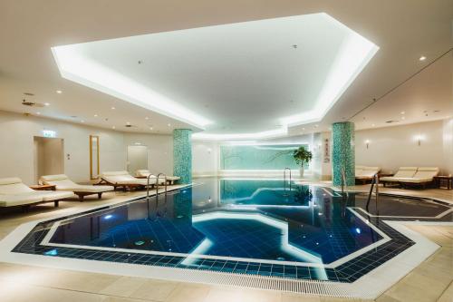 a swimming pool in the middle of a building at Hilton Berlin in Berlin
