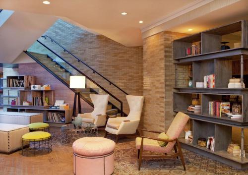 a library with chairs and tables and a staircase at DoubleTree by Hilton Hotel Nashville Downtown in Nashville