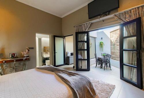 a bedroom with a bed and a large glass door at Laru home in Germiston