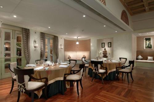 a dining room with tables and chairs in a room at Hilton Mumbai International Airport Hotel in Mumbai