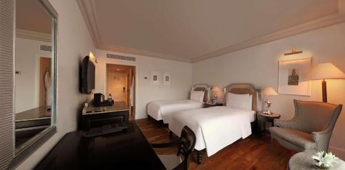 a hotel room with two beds and a television at Hilton Mumbai International Airport Hotel in Mumbai