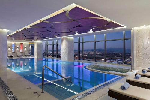 a hotel swimming pool with a view of the city at Hilton Bursa Convention Center & Spa in Bursa