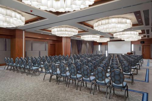 a room with rows of chairs in a room with chandeliers at Hilton Bursa Convention Center & Spa in Bursa