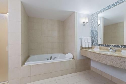 a bathroom with a tub and a sink at Hilton Garden Inn Annapolis in Annapolis