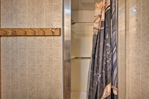 a shower with a shower curtain in a bathroom at 5 Mi to Raystown Lake Launch Lucas McCain Cabin in Huntingdon