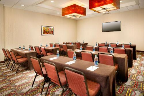a conference room with tables and chairs and a flat screen tv at Hampton Inn & Suites Chattanooga/Hamilton Place in Chattanooga