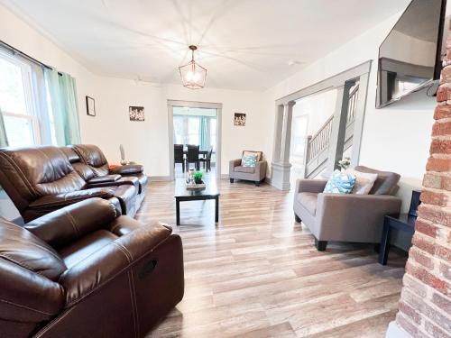 a living room with a couch and a chair at Centrally Located 5BR house in Niagara Falls in Niagara Falls