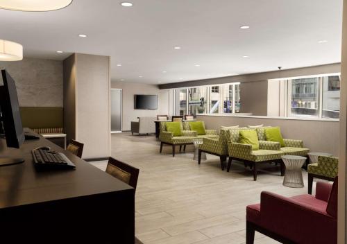 a lobby with green chairs and a waiting room at Hampton Inn Chicago Downtown/Magnificent Mile in Chicago