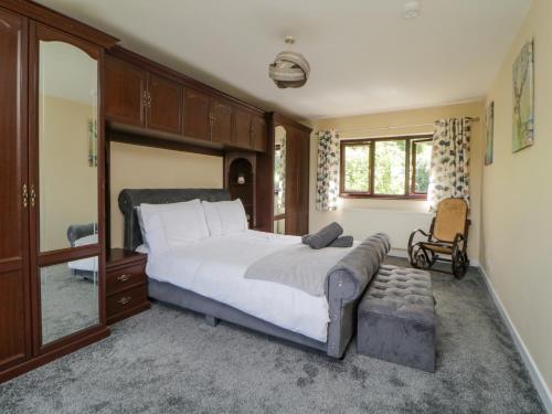 a bedroom with a bed and a chair in it at Moorstone in Okehampton