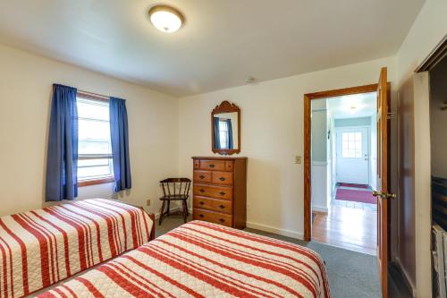 a bedroom with two beds and a dresser and a mirror at Shorefront House with Views, 14 Mi to Acadia NP in Sullivan