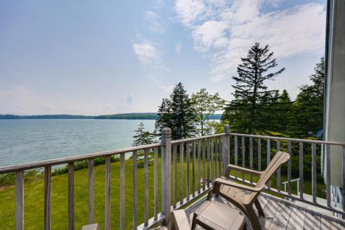 a balcony with a chair and a view of the water at Shorefront House with Views, 14 Mi to Acadia NP in Sullivan