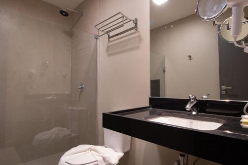 a bathroom with a sink and a shower at Maceio Mar Resort All Inclusive in Maceió