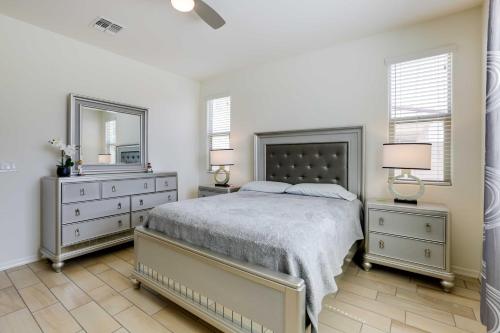 1 dormitorio con 1 cama, 2 vestidores y espejo en 3 Mi to Goodyear Ballpark Desert Den with Pool, en Goodyear
