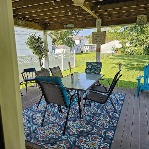 a patio with a table and chairs on a deck at Relaxing Stay Near the Beach in Hampton