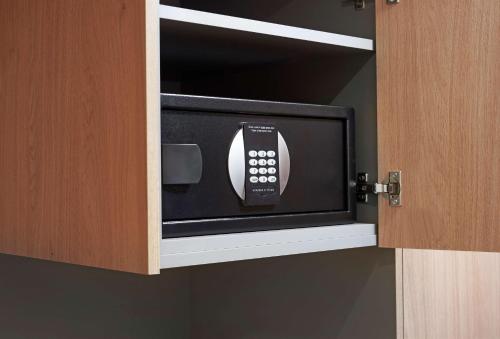 a microwave oven in a cabinet in a kitchen at Hilton Cobham in Cobham