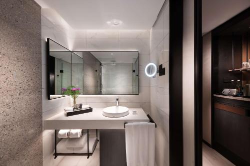 a bathroom with a sink and a mirror at Hilton Colombo Hotel in Colombo