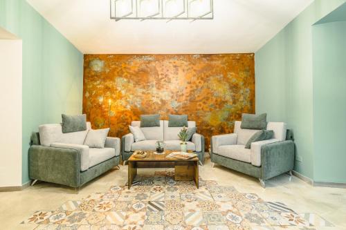 a living room with two couches and a painting at BeB Omare Agrigento in Agrigento