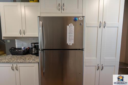 a stainless steel refrigerator in a kitchen with white cabinets at 3BR Condo with Lake View - Trout Fishing - Playground - 2 Pools - Stairs Required - FREE TICKETS INCLUDED - PR69-9 in Branson