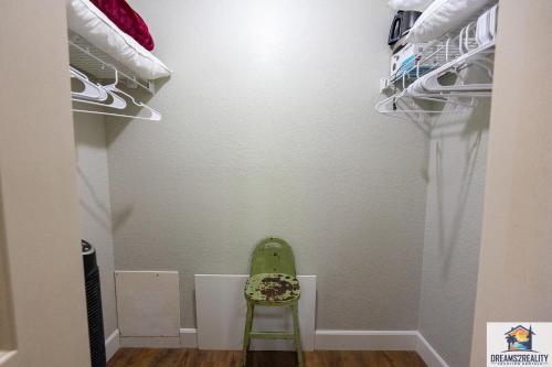 a green chair sitting in a closet at 3BR Condo with Lake View - Trout Fishing - Playground - 2 Pools - Stairs Required - FREE TICKETS INCLUDED - PR69-9 in Branson
