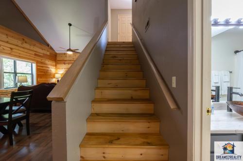 a staircase in a home with wooden floors at 3BR Condo with Lake View - Trout Fishing - Playground - 2 Pools - Stairs Required - FREE TICKETS INCLUDED - PR69-9 in Branson