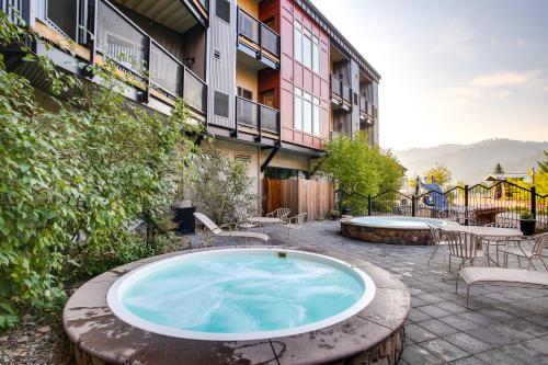 a hot tub on a patio in front of a building at Pet-Friendly Silver Mountain Studio Mountain View in Kellogg