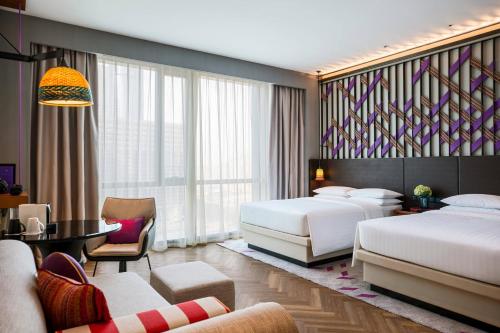 a hotel room with two beds and a table at Renaissance Nanning Hotel in Nanning